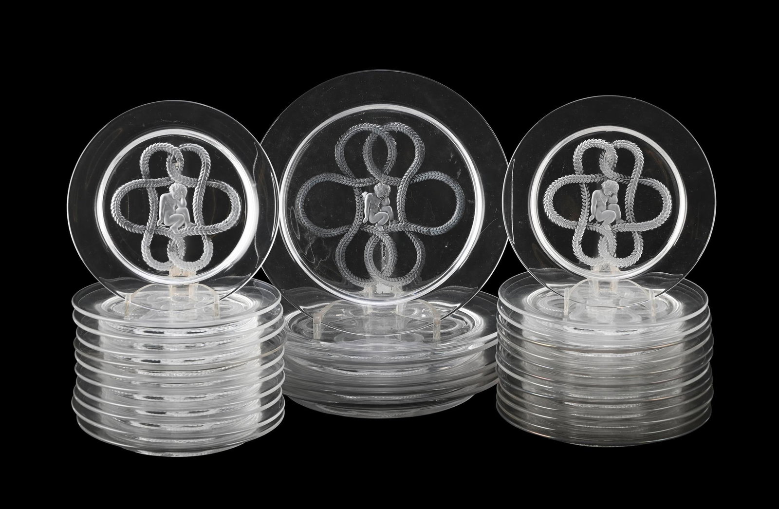 LALIQUE, 'OLYMPE' PART DINNER SERVICE; POST 1945: LALIQUE'OLYMPE' PART DINNER SERVICE; POST 1945Frosted and clear glass; cherub and knots detailComprising of twelve side plates, twelve small plates and six larger plates Signed 'Lalique France'Side pl
