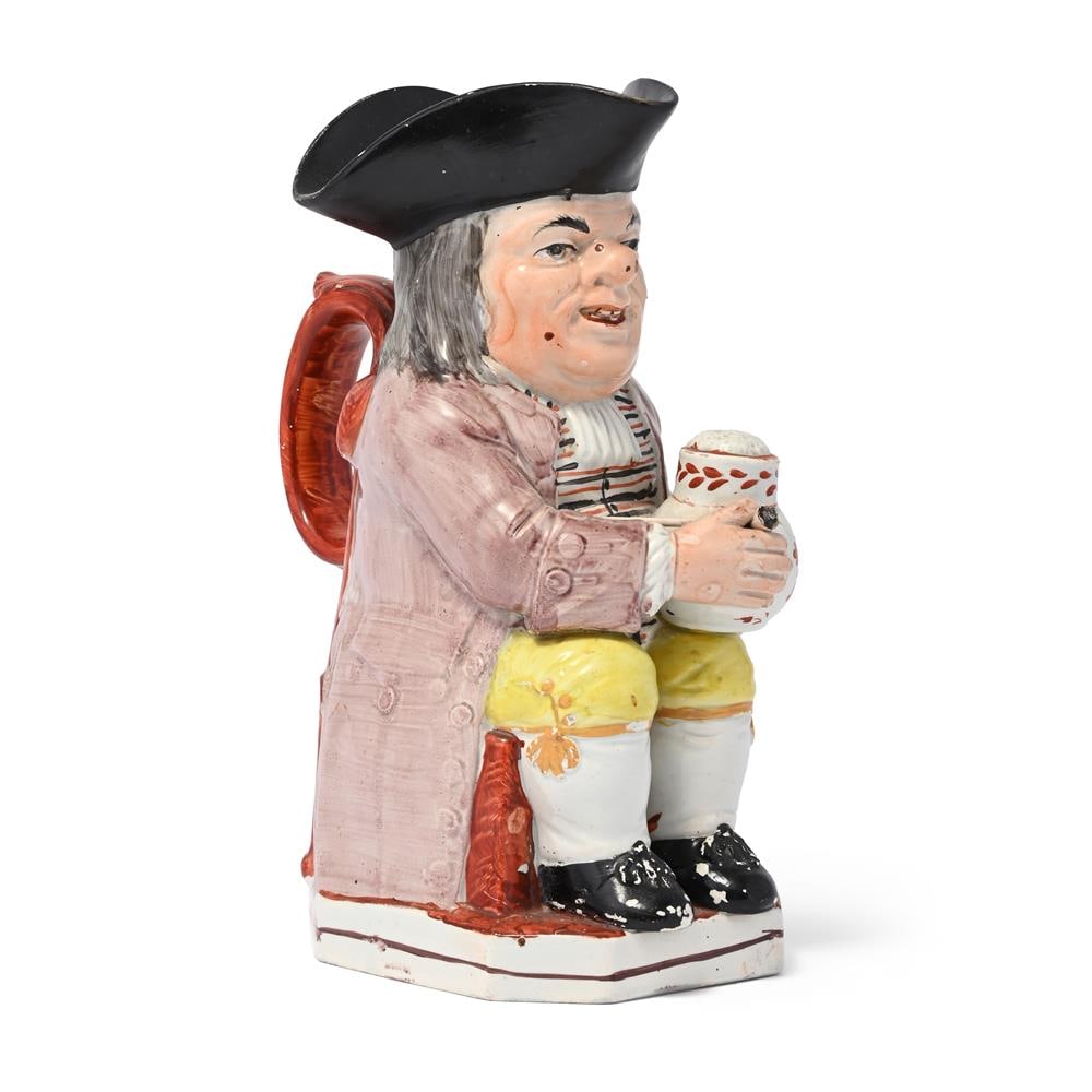 A STAFFORDSHIRE PEARLWARE PIPE-SMOKING TOBY JUG, CIRCA 1830: A STAFFORDSHIRE PEARLWARE PIPE-SMOKING TOBY JUG CIRCA 1830 24.5cm high Condition Report: PLEASE NOTE: ALL LOTS ARE LOCATED AT SACKVILLE WEST STORAGE IN ANDOVER (SP10 3SA) AND ARE NOT AVAILABLE TO