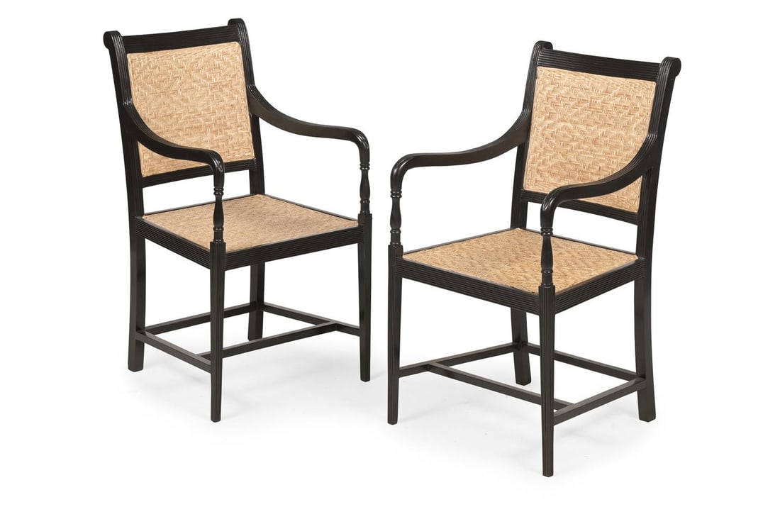 Y A PAIR OF EBONY ARMCHAIRS, IN GEORGE III STYLE, LATE 20TH OR EARLY 21ST CENTURY: Y A PAIR OF EBONY ARMCHAIRS IN GEORGE III STYLE, PROBABLY INDIAN, LATE 20TH OR EARLY 21ST CENTURY Each with woven split cane mat panel seats and backs and with a corresponding loose squab