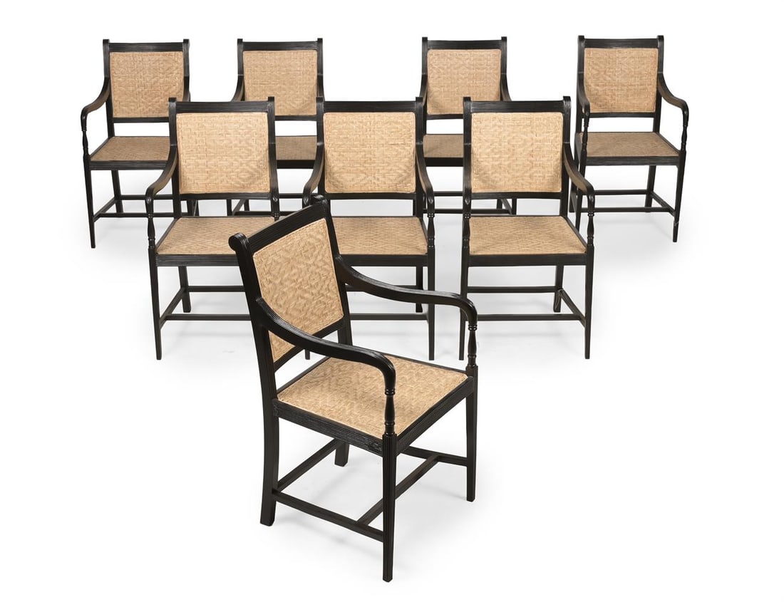 Y A SET OF EIGHT EBONY ARMCHAIRS, IN GEORGE III STYLE, LATE 20TH OR EARLY 21ST CENTURY: Y A SET OF EIGHT EBONY ARMCHAIRS IN GEORGE III STYLE, PROBABLY INDIAN, LATE 20TH OR EARLY 21ST CENTURY Each with woven split cane mat panel seats and backs each with a corresponding loose squab