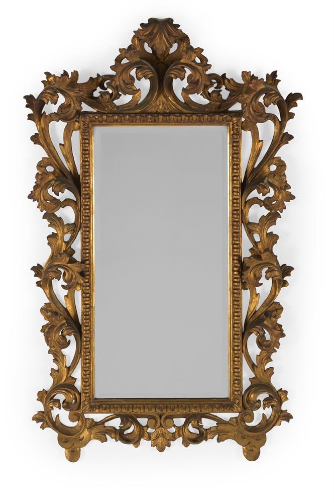 A CARVED AND GILT WOOD WALL MIRROR, IN FLORENTINE STYLE, EARLY 20TH CENTURY (1 of 2)