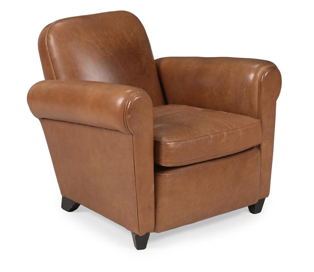 A LEATHER UPHOLSTERED LOW CLUB ARMCHAIR: A LEATHER UPHOLSTERED LOW CLUB ARMCHAIR