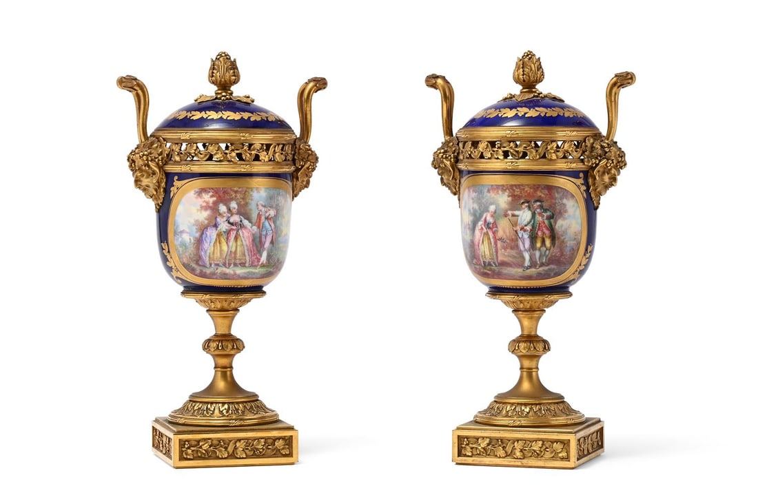 A PAIR OF FRENCH ORMOLU MOUNTED PORCELAIN POT POURRI VASES WITH PANELS BY L SCHILT, 19TH CENTURY: A PAIR OF FRENCH (PARIS) ORMOLU MOUNTED PORCELAIN POT POURRI VASES WITH PANELS BY L SCHILT 19TH CENTURY In the Sevres manner, urn shaped, the lids with fruit knops, the gros bleu and gilt porcelain