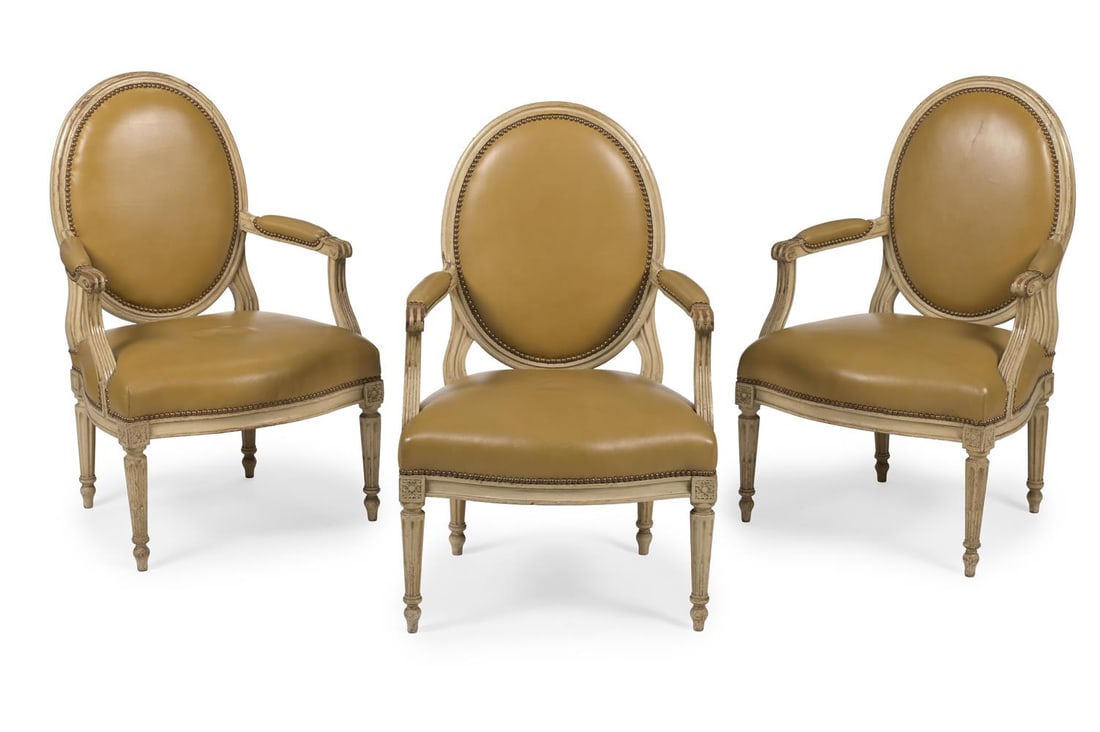 A GROUP OF THREE BEECHWOOD AND LEATHER UPHOLSTERED FAUTEUILS, FRENCH, SECOND HALF 19TH CENTURY: A GROUP OF THREE BEECHWOOD AND LEATHER UPHOLSTERED FAUTEUILS FRENCH, SECOND HALF 19TH CENTURY With beige leather close nailed upholstery 100cm high, 62cm wide, 58cm deep Condition Report: PLEASE