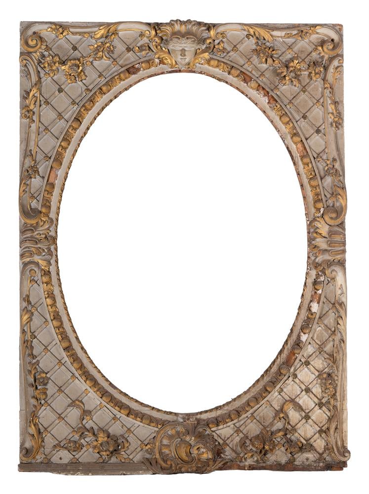 A LARGE PAINTED AND PARCEL GILT ARCHITECTURAL FRAME, FRENCH, PROBABLY LAST QUARTER 18TH CENTURY: A LARGE PAINTED AND PARCEL GILT ARCHITECTURAL FRAME WITH OVAL MASK FRENCH, PROBABLY LAST QUARTER 18TH CENTURY Carved with the mask of Liberty and flowering trellis 162cm high, 115cm wide Condition