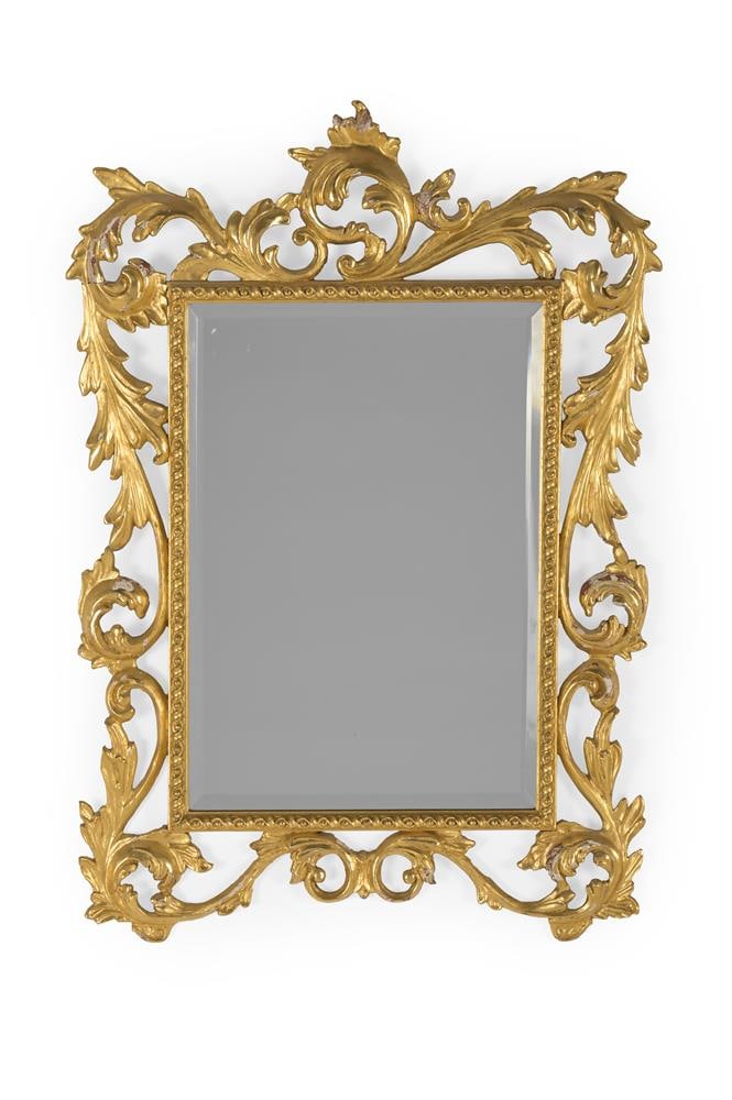 A CARVED WOOD AND GILT GESSO RECTANGULAR WALL MIRROR, FLORENTINE, LATE 19TH OR EARLY 20TH CENTURY: A CARVED WOOD AND GILT GESSO RECTANGULAR WALL MIRROR