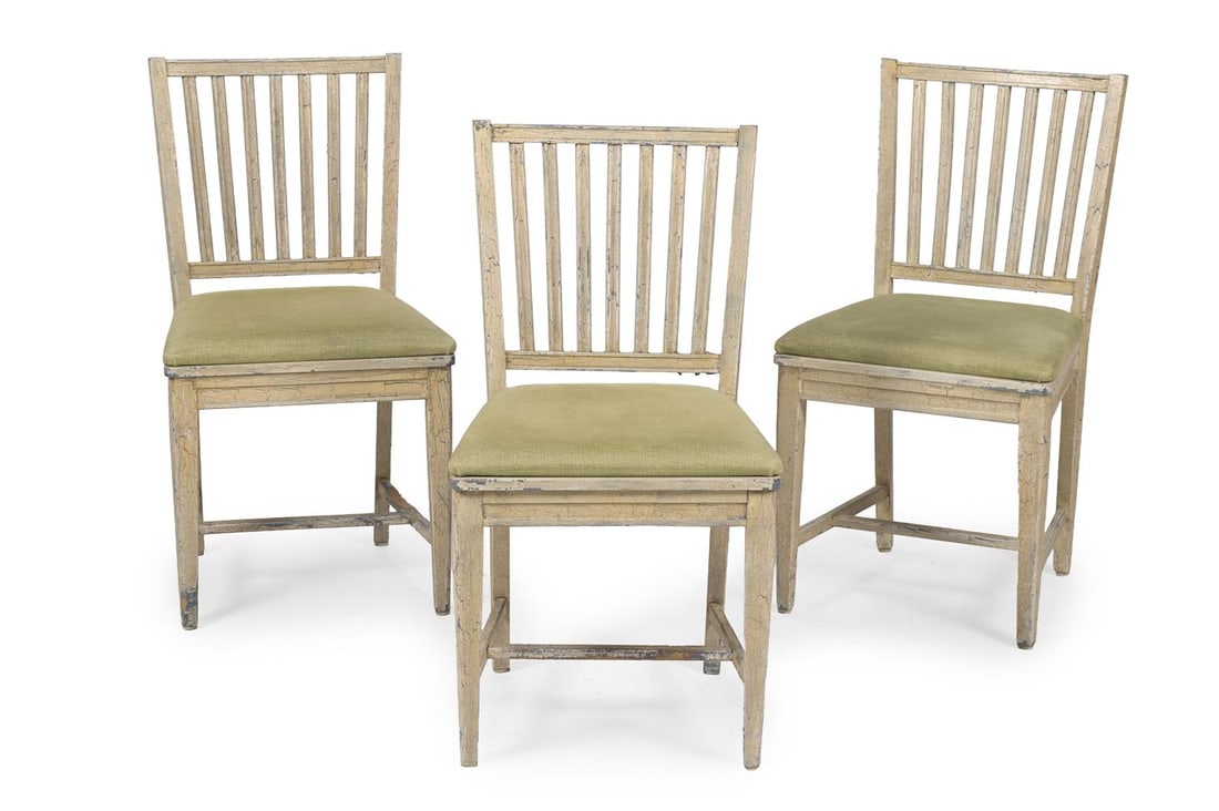 A SET OF THREE PAINTED OAK SIDE CHAIRS, IN LATE 18TH CENTURY STYLE, FIRST HALF 20TH CENTURY: A SET OF THREE PAINTED OAK SIDE CHAIRS IN LATE 18TH CENTURY STYLE, FIRST HALF 20TH CENTURY With decorative distressed paint finish and upholstered seats 87cm high, 48cm wide, 50cm deep Condition