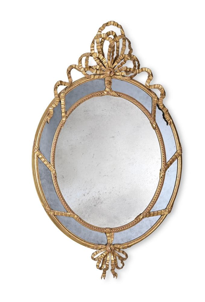 A GILTWOOD OVAL WALL MIRROR, IN THE MANNER OF JOHN LINNELL, LATE 19TH OR 20TH CENTURY: A GILTWOOD OVAL WALL MIRROR IN THE MANNER OF JOHN LINNELL, LATE 19TH OR 20TH CENTURY 138cm high, 88cm wide Condition Report: Marks, knocks, scratches and abrasions commensurate with age and use The