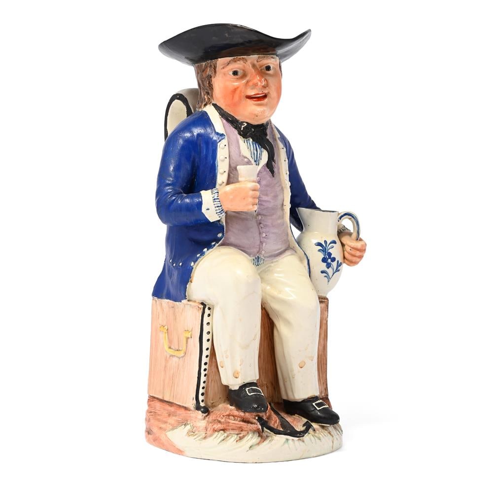 A STAFFORDSHIRE PEARLWARE 'SAILOR' TOBY JUG, CIRCA 1800: A STAFFORDSHIRE PEARLWARE 'SAILOR' TOBY JUG CIRCA 1800 Typically modelled seated on a sea chest, 29cm high Condition Report: PLEASE NOTE: ALL LOTS ARE LOCATED AT SACKVILLE WEST STORAGE IN