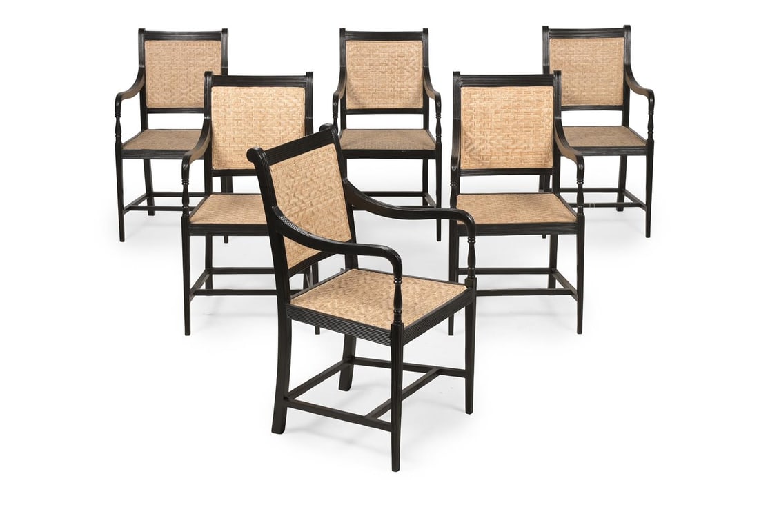Y A SET OF SIX EBONY ARMCHAIRS, IN GEORGE III STYLE, LATE 20TH OR EARLY 21ST CENTURY: Y A SET OF SIX EBONY ARMCHAIRS IN GEORGE III STYLE, PROBABLY INDIAN, LATE 20TH OR EARLY 21ST CENTURY Each with woven split cane mat panel seats and backs each with a corresponding loose squab