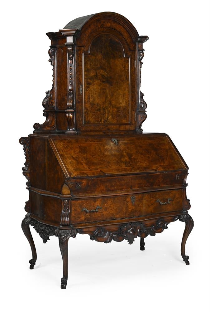 A CONTINENTAL CARVED AND FIGURED WALNUT BUREAU CABINET, LATE 18TH OR EARLY 19TH CENTURY: A CONTINENTAL CARVED AND FIGURED WALNUT BUREAU CABINET