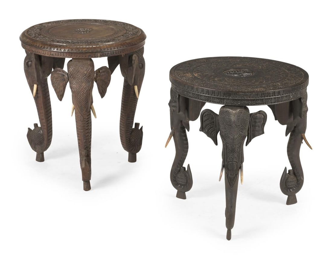 Y A MATCHED PAIR OF ANGLO INDIAN BOMBAY BLACKWOOD ELEPHANT SIDE TABLES, SECOND HALF 19TH CENTURY: Y A MATCHED PAIR OF ANGLO INDIAN CARVED BOMBAY BLACKWOOD ELEPHANT SIDE TABLES SECOND HALF 19TH CENTURY With ivory tusks the larger 53cm high, 46cm diameter, the smaller 49.5cm high, 45.5cm