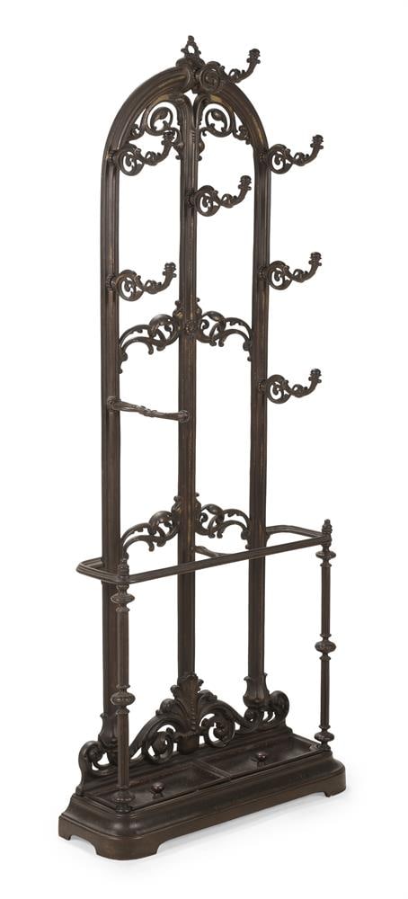 A VICTORIAN CAST IRON HALL STAND, IN THE MANNER OF DESIGNS BY ROTHERHAM, YATES, HAYWOOD & CO: A VICTORIAN CAST IRON HALL STAND IN THE MANNER OF DESIGNS BY ROTHERHAM, YATES, HAYWOOD & CO, CIRCA 1880 With removable drip trays 182cm high, 70cm wide, 20cm deep Note: A similar model but with