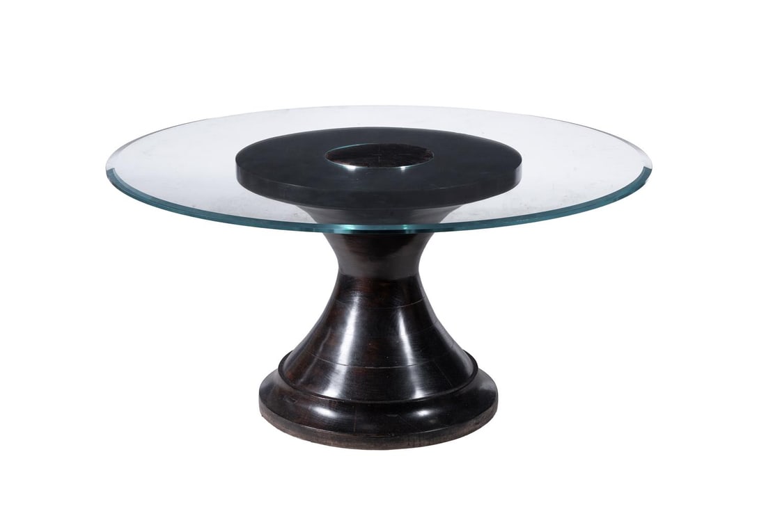 AN EBONISED WOOD AND GLASS TOPPED CIRCULAR DINING TABLE, MODERN: AN EBONISED WOOD AND PLATE GLASS TOPPED CIRCULAR DINING TABLE