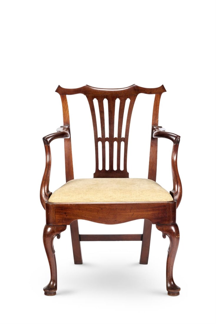 A GEORGE II MAHOGANY ARMCHAIR, MID 18TH CENTURY, POSSIBLY IRISH: A GEORGE II MAHOGANY ARMCHAIRMID 18TH CENTURY, POSSIBLY IRISHThe yoke toprail and pierced splat above a padded drop in seat on scroll-carved cabriole legs with pad feet98cm high, 67cm wide, 58cm deep