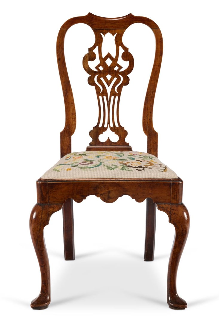 A GEORGE II WALNUT SIDE CHAIR, CIRCA 1730: A GEORGE II WALNUT SIDE CHAIRCIRCA 1730The yoke top rail and pierced interlaced splat above a needlework upholstered drop-in seat and shaped rails, on cabriole legs with pad feetProvenance:Acquired fr