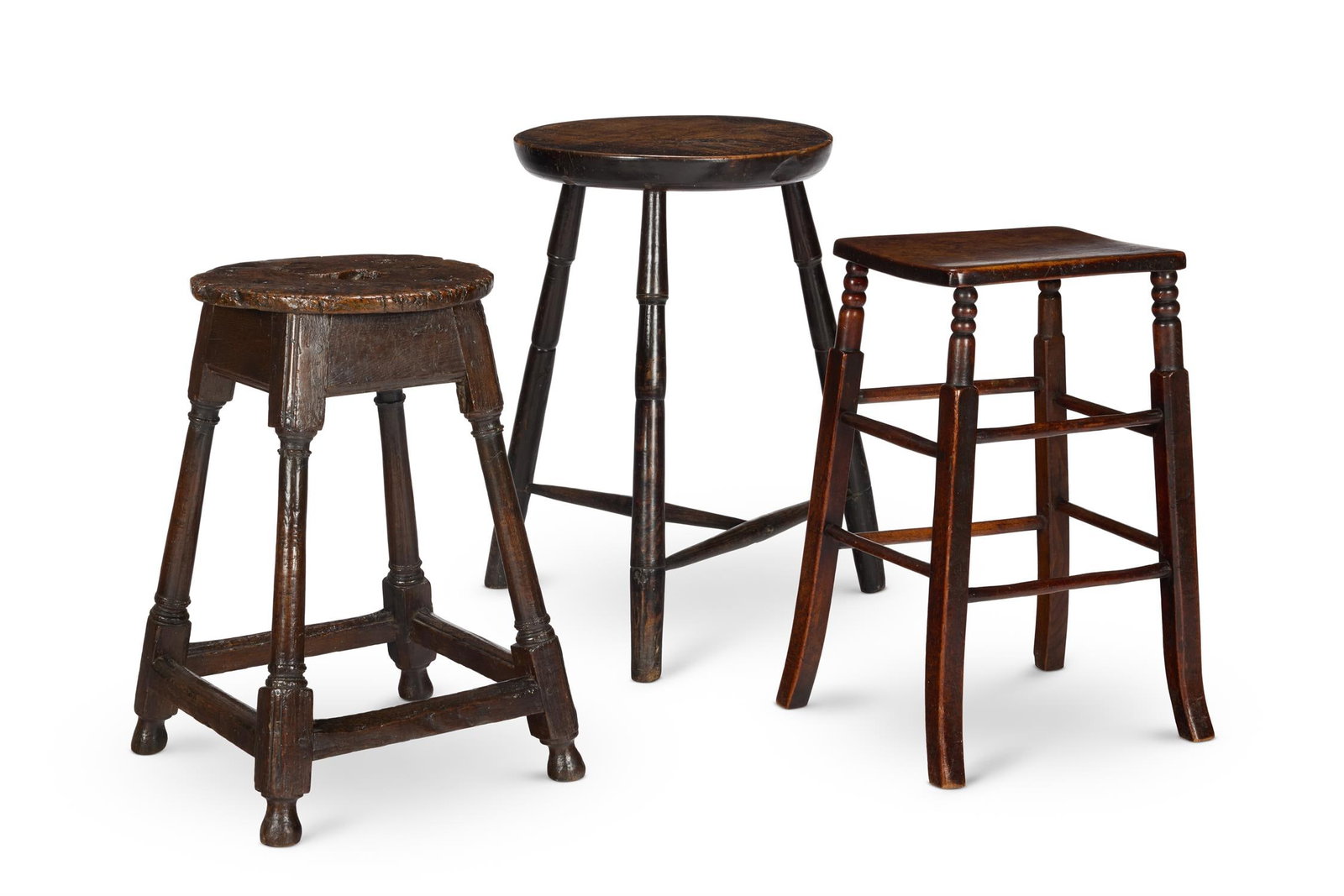 A FRUITWOOD AND ASH CRICKET TABLE, 19TH CENTURY: A FRUITWOOD AND ASH CRICKET TABLE19TH CENTURYThe circular top with a moulded lip on turned legs joined by stretchers61cm high, 38cm diameterTogether with oak and burr oak joined stool,18th century, th