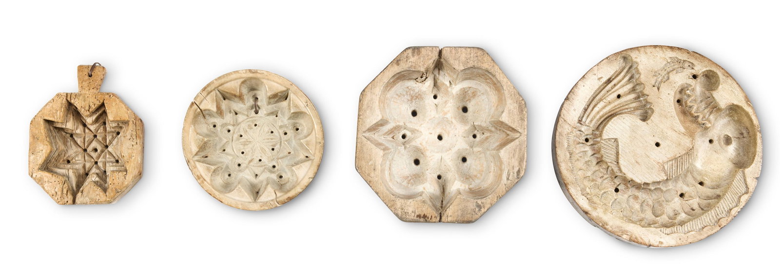 A COLLECTION OF FOUR SYCAMORE CHEESE AND BREAD MOULDS, 19TH CENTURY: A COLLECTION OF FOUR SYCAMORE CHEESE AND BREAD MOULDS 19TH CENTURY Two circular, the largest carved with a fish and two octagonal examples largest 35cm diameter