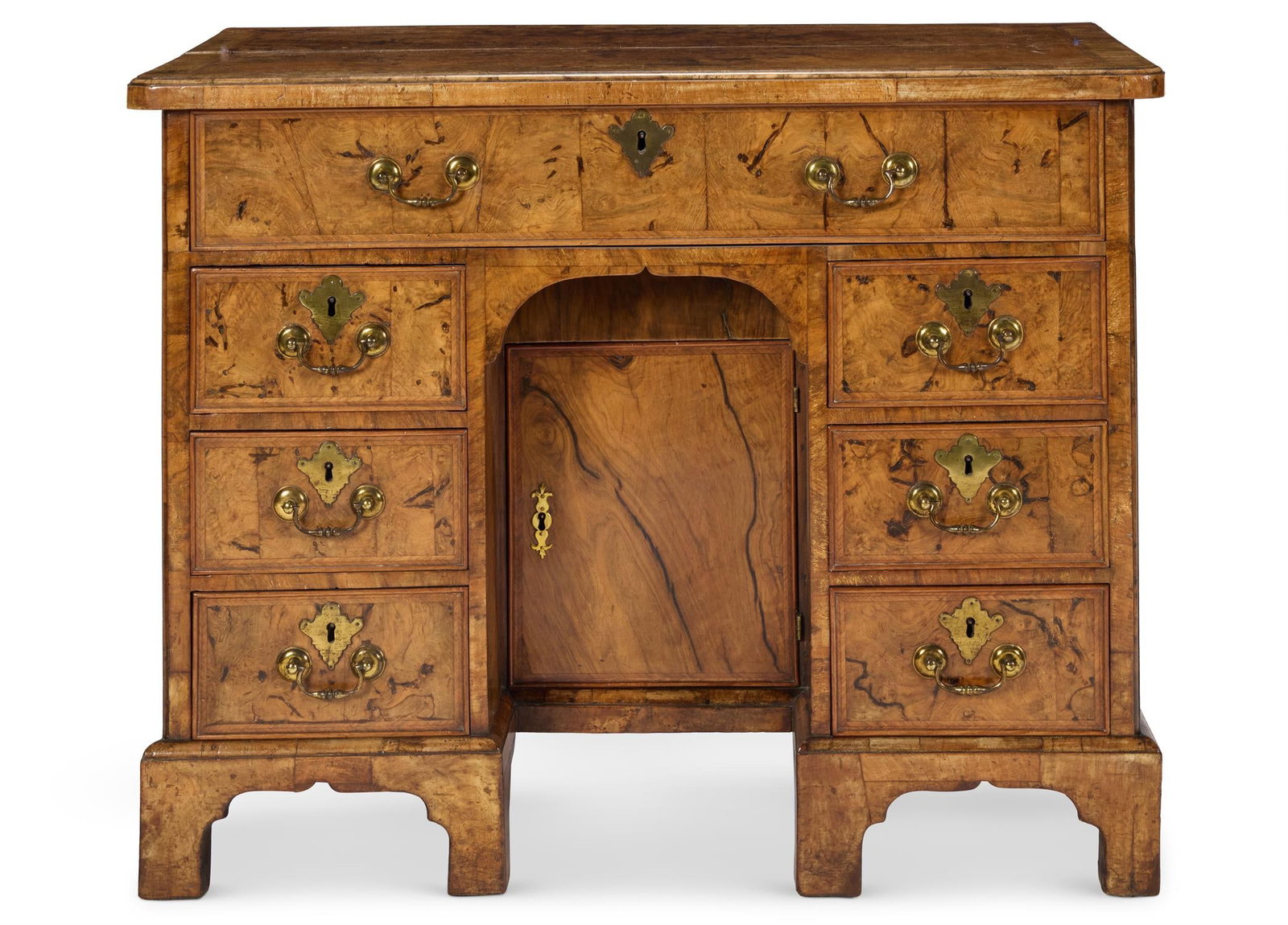 A GEORGE II WALNUT KNEEHOLE DESK OR DRESSING-TABLE, CIRCA 1720 (1 of 2)