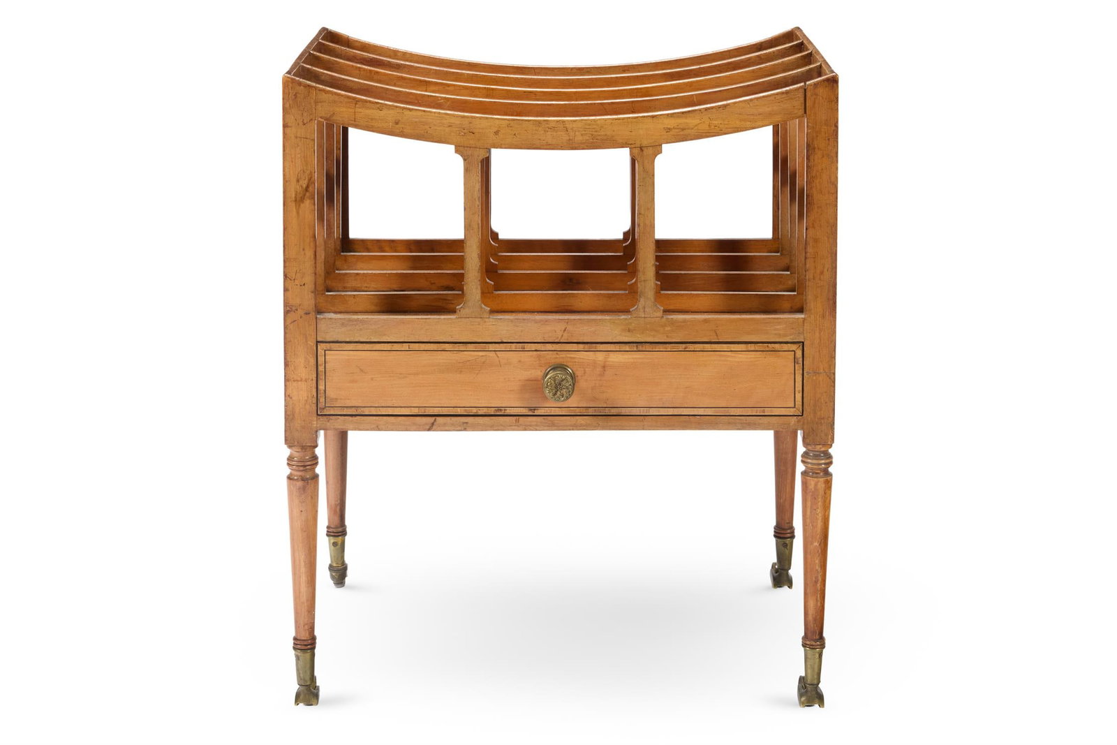 A REGENCY SATINWOOD AND CROSSBANDED CANTERBURY, CIRCA 1815: A REGENCY SATINWOOD AND CROSSBANDED CANTERBURYCIRCA 1815Of four slatted divisions above a single drawer on slender turned legs with brass caps and castors54cm high, 46cm wide, 31cm deep Provenance:Acq