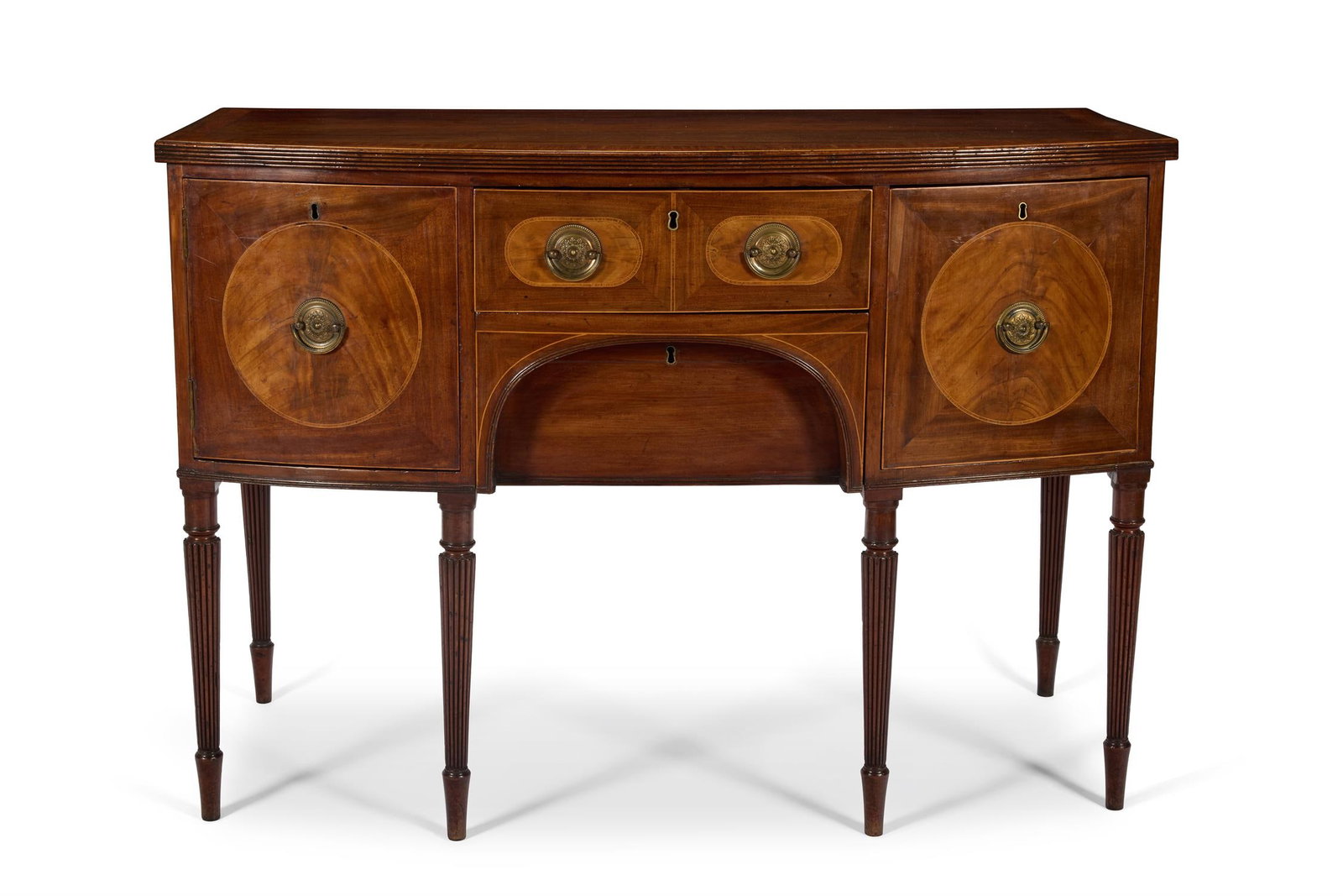 A REGENCY MAHOGANY AND SATINWOOD BOWFRONT SIDEBOARD, CIRCA 1815, POSSIBLY BY GILLOWS: A REGENCY MAHOGANY AND SATINWOOD BOWFRONT SIDEBOARDCIRCA 1815, POSSIBLY BY GILLOWSThe shaped crossbanded top with a reeded edge above a drawer and another recessed arched drawer flanked by a cupboard