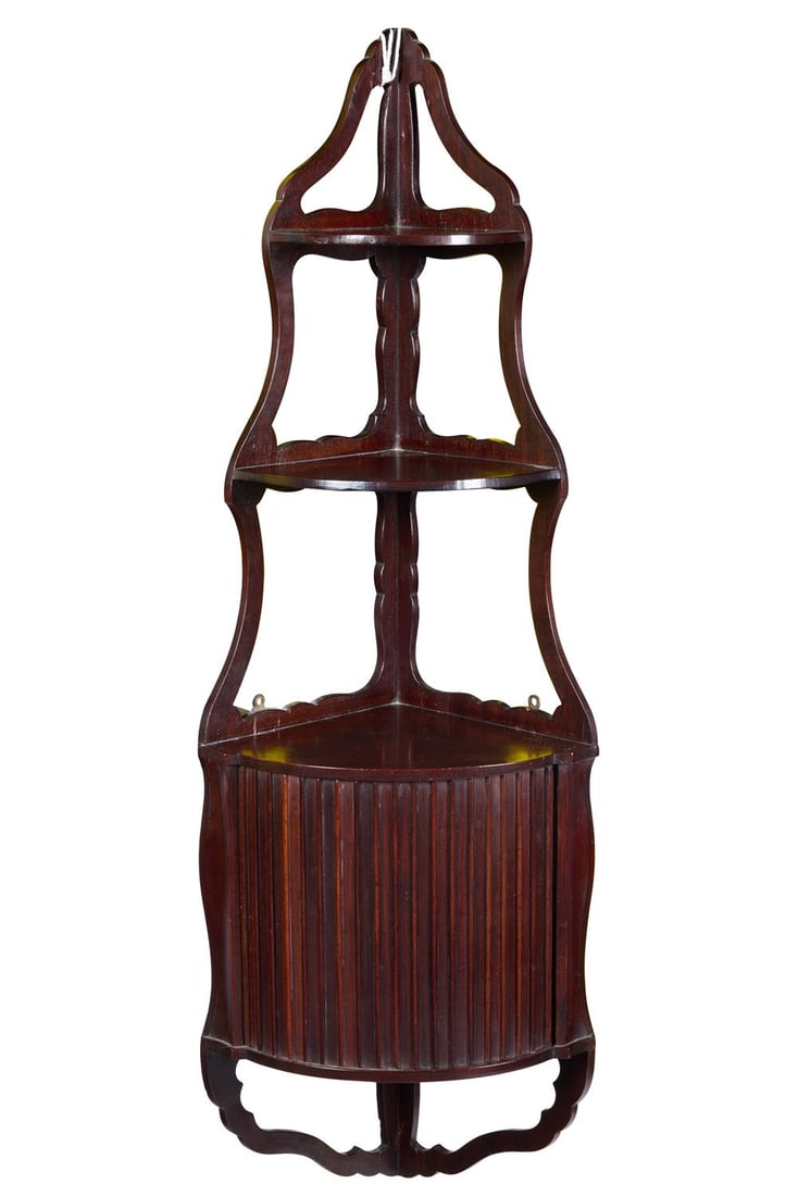 A SET OF MAHOGANY CORNER HANGING SHELVES, CIRCA 1800, POSSIBLY DUTCH: A SET OF MAHOGANY CORNER HANGING SHELVESCIRCA 1800, POSSIBLY DUTCHOf two open shelves above a tambour96cm high, 32cm wideProvenance: Acquired from John G. Morris Ltd, Petworth