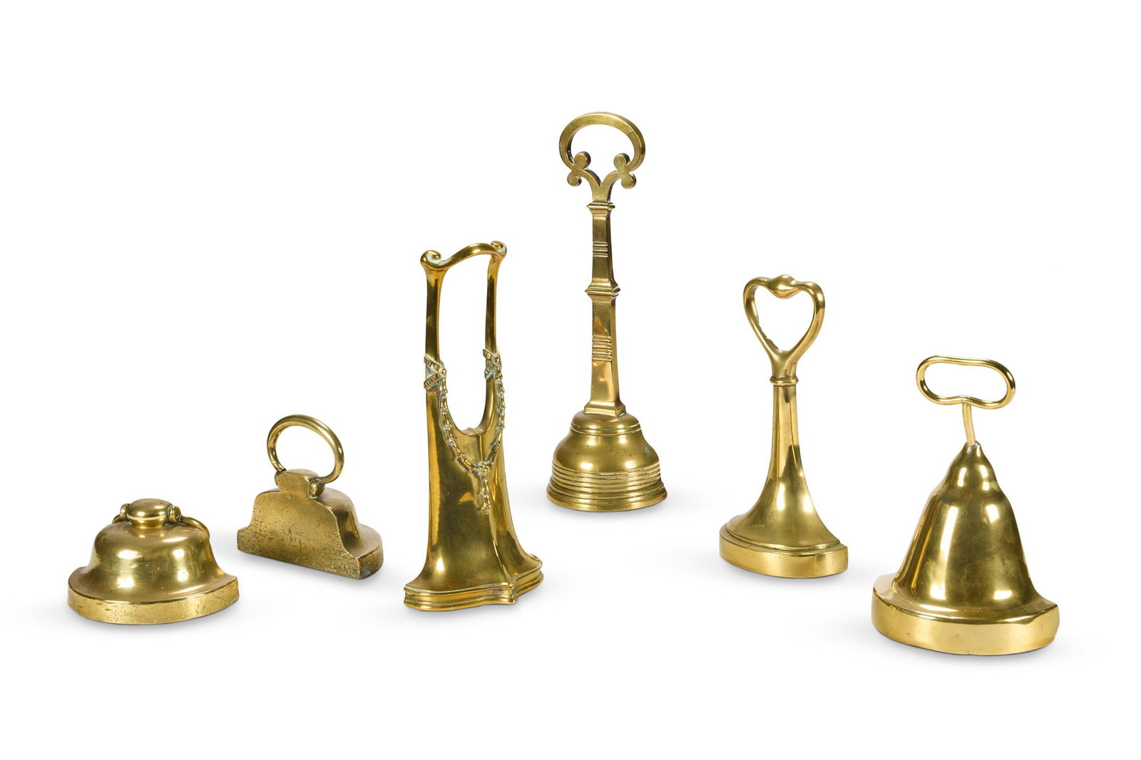 A GROUP OF SIX BRASS DOOR PORTERS OR DOOR STOPS 19TH AND EARLY 20TH CENTURY Including a pair lar (1 of 1)