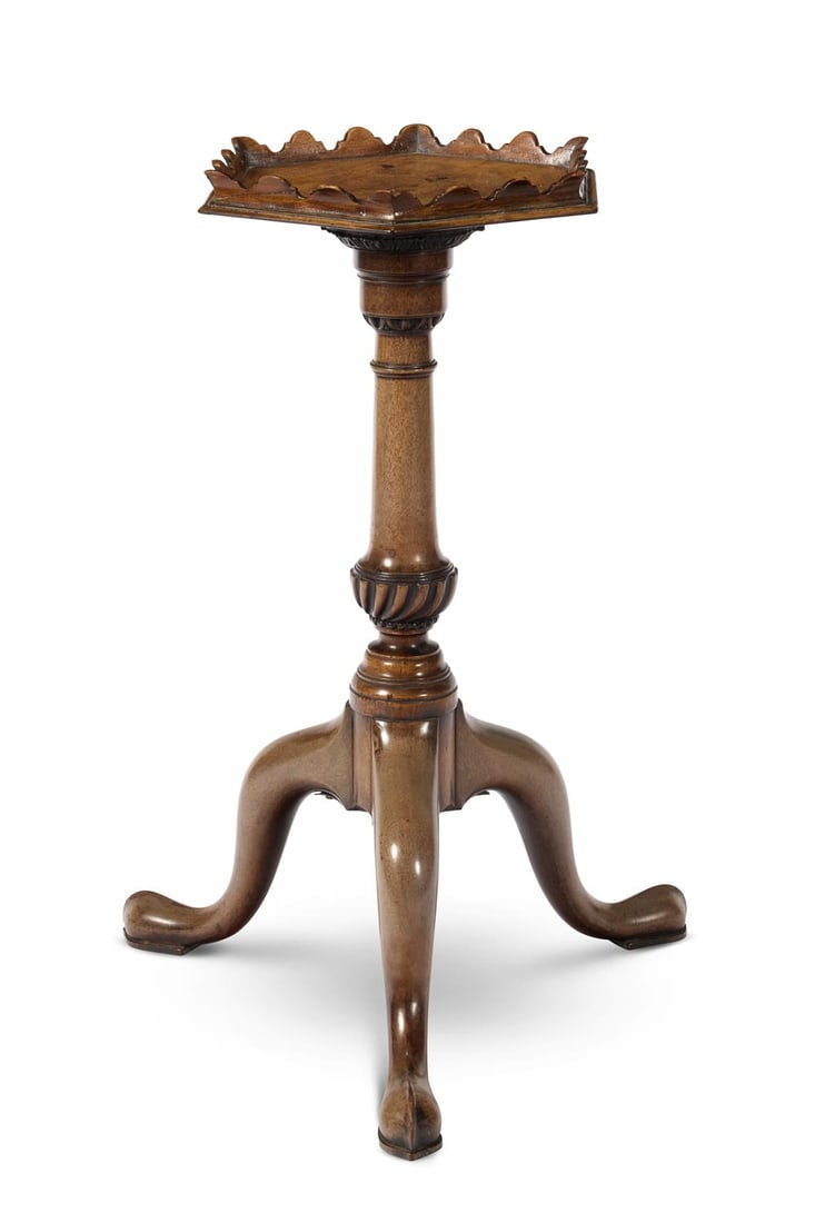 A GEORGE II MAHOGANY MAHOGANY TRIPOD TABLE, CIRCA 1750: A GEORGE II MAHOGANY MAHOGANY TRIPOD TABLECIRCA 1750The hexagonal top with an everted scalloped gallery on a turned column with egg-and-dart and foliate-carved collars and spiral knop on three downswe