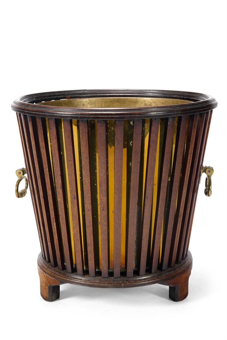 A GEORGE III MAHOGANY AND BRASS JARDINIERE, CIRCA 1800: A GEORGE III MAHOGANY AND BRASS JARDINIERECIRCA 1800The slatted sides with brass handles and a later brass liner42cm highProvenance:Anonymous sale, Christie's, London,27 September 2000