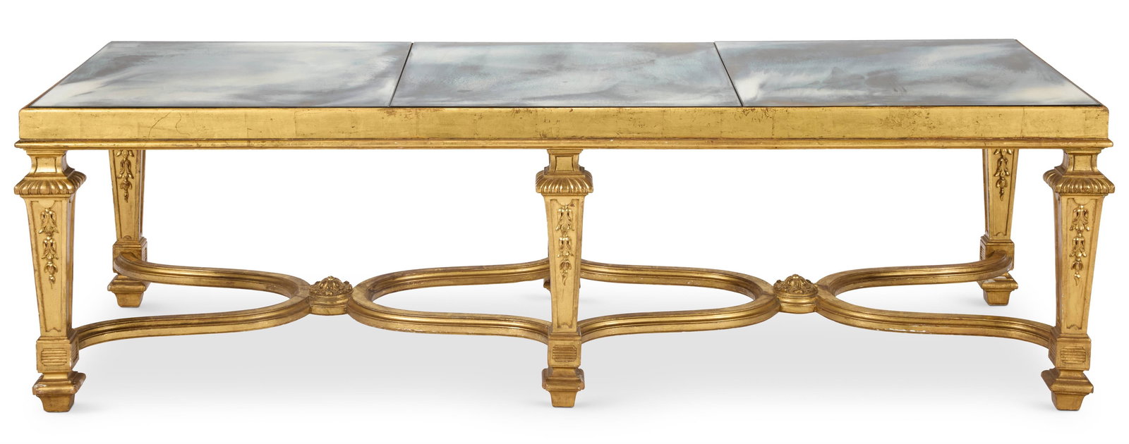 A GILTWOOD AND MIRRORED LOW TABLE, EARLY 20TH CENTURY, OF LOUIS XIV STYLE: A GILTWOOD AND MIRRORED LOW TABLEEARLY 20TH CENTURY, OF LOUIS XIV STYLEThe rectangular top on square tapering legs with reeded collars joined by shaped stretchers44cm high, 151cm long, 53cm deep