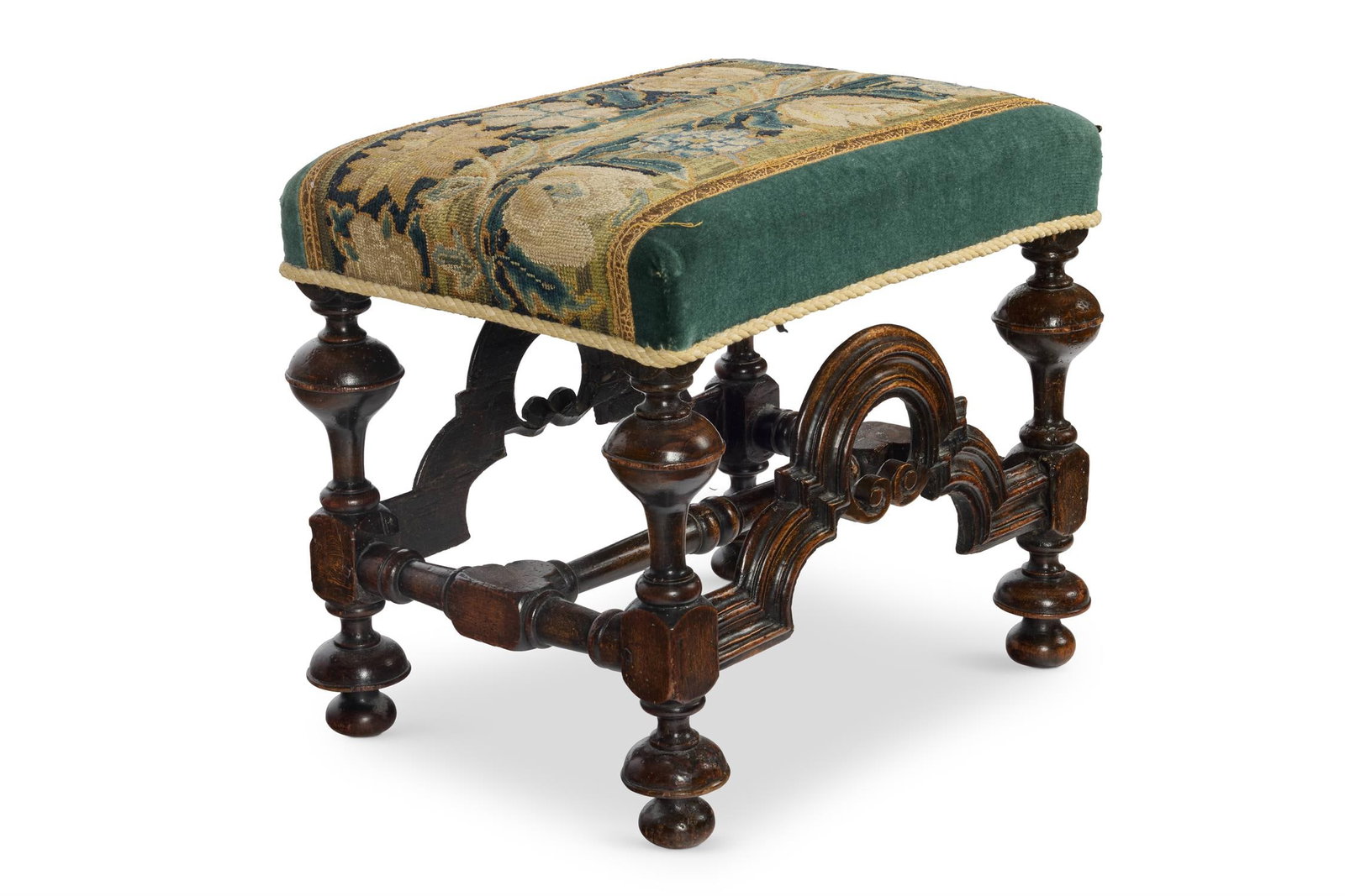 A CHARLES II WALNUT STOOL, CIRCA 1680: A CHARLES II WALNUT STOOLCIRCA 1680The padded and later needlework and velvet upholstered seat on turned and square section legs, with moulded arched stretchers to front and rear and with additional t