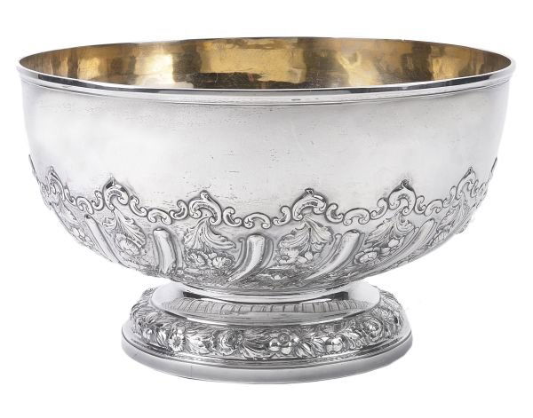 A late Victorian silver pedestal punch bowl by Cha: A late Victorian silver pedestal punch bowl by Charles Stuart Harris, London 1897, the half spiralling lobed body alternating with embossed foliate swags and on a circular foot with an embossed foliat