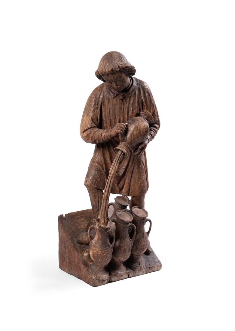 A CARVED OAK FIGURE OF A SERVANT POURING WINE AT THE WEDDING FEAST AT CANA. FLEMISH: A CARVED OAK FIGURE OF A SERVANT POURING WINE AT THE WEDDING FEAST AT CANAFLEMISH, PROBABLY EARLY 16TH CENTURY51.5cm high It is likely that lots 22 and 23 originally formed part of a larger figural gr