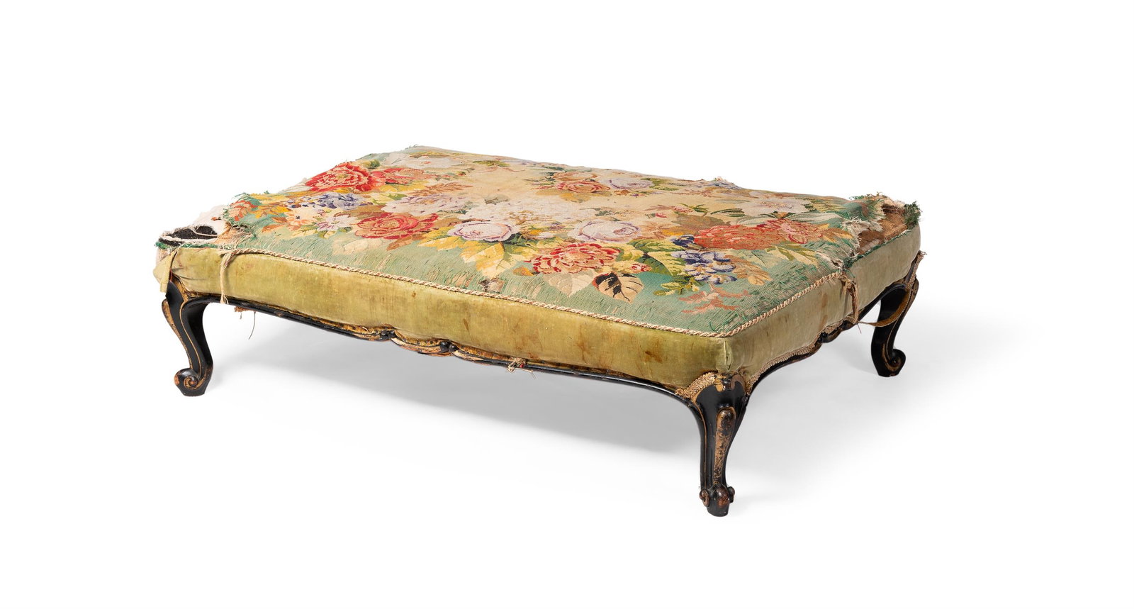 A MID VICTORIAN EBONISED AND PARCEL GILT STOOL, THIRD QUARTER 19TH CENTURY: A MID VICTORIAN EBONISED AND PARCEL GILT STOOL THIRD QUARTER 19TH CENTURYThe rectangular padded and gros-point floral needlework seat above shaped rails and short moulded cabriole legs 31cm high, 118c