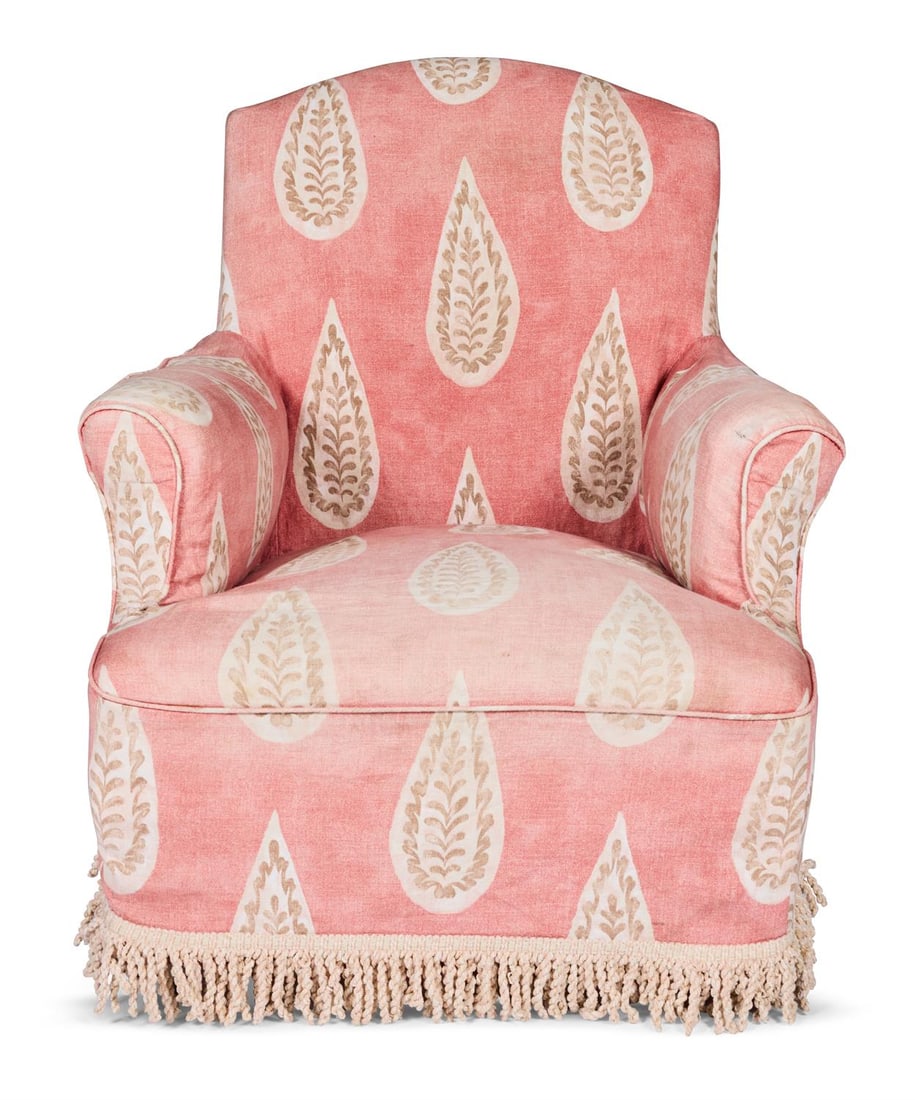 AN EARLY VICTORIAN UPHOLSTERED EASY ARMCHAIR,CIRCA 1840: AN EARLY VICTORIAN UPHOLSTERED EASY ARMCHAIRCIRCA 1840With an arched padded back and out-turned arms on turned tapering mahogany legs with brass caps and castors