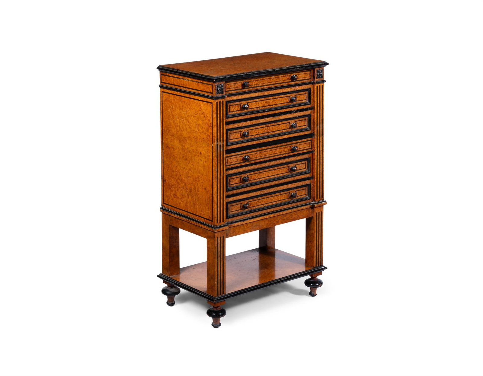 Y A MID VICTORIAN AMBOYNA AND EBONY COLLECTOR'S CABINET, THIRD QUARTER 19TH CENTURY: Y A MID VICTORIAN AMBOYNA AND EBONY COLLECTOR'S CABINET THIRD QUARTER 19TH CENTURYOf six mahogany lined drawers and an open shelf below on short turned feet73cm high, 45cm wide, 27cm deep ϒ Indic