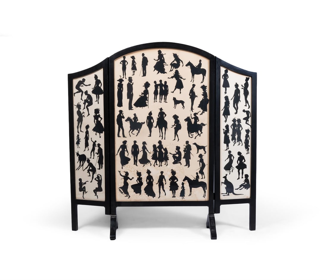 AN EBONISED THREE FOLD FIRE SCREEN, SECOND HALF 20TH CENTURY: AN EBONISED THREE FOLD FIRE SCREENSECOND HALF 20TH CENTURYInset with printed silhouette pattern paper 102cm high, 102cm wide