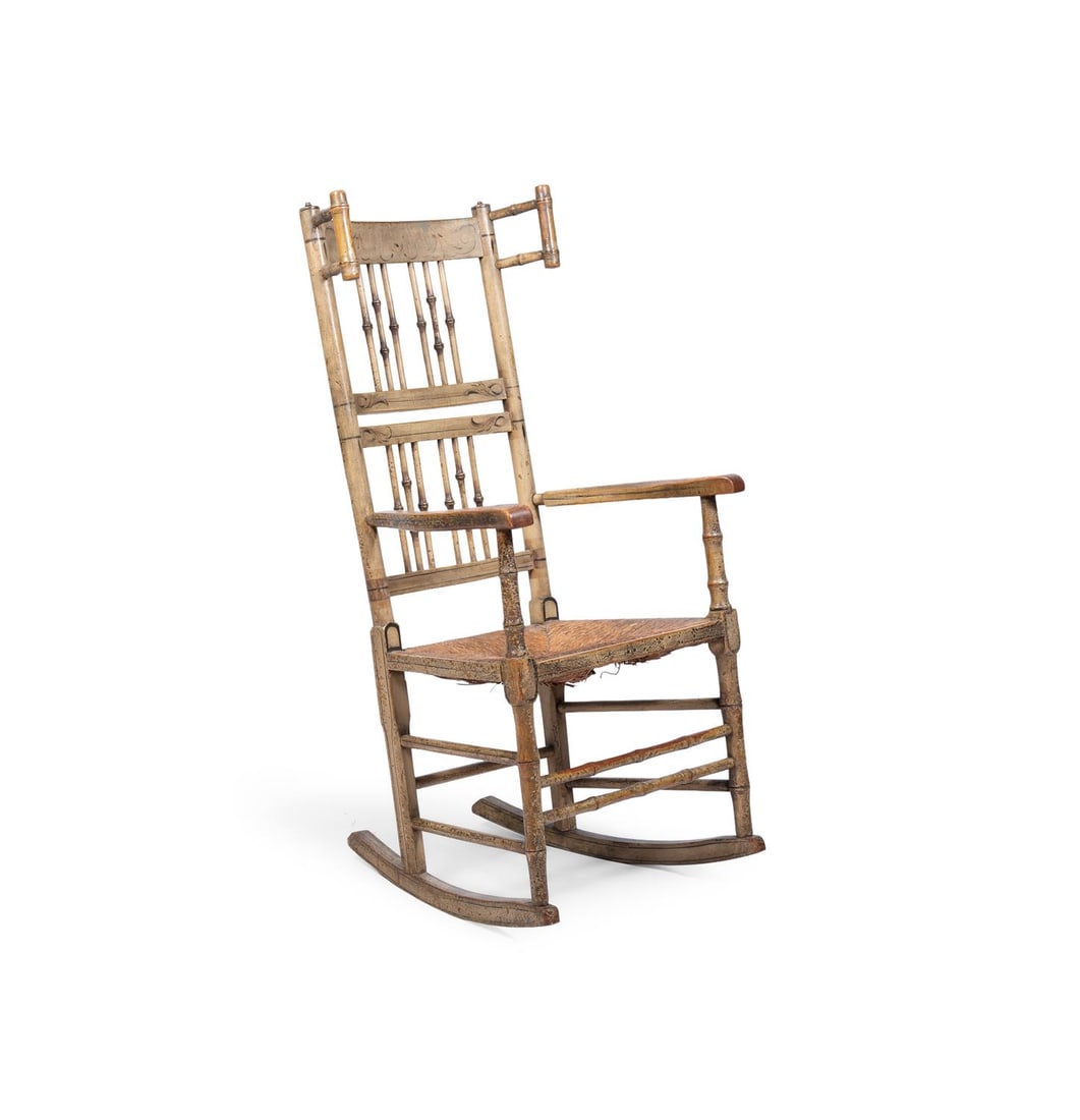 A CREAM PAINTED ASH AND BEECH SPINDLE BACK ROCKING CHAIR, EARLY 19TH CENTURY: A CREAM PAINTED ASH AND BEECH SPINDLE BACK ROCKING CHAIREARLY 19TH CENTURYThe spindles modelled as bamboo, the back with foliate decoration and with a rush seat115cm high, 55cm wide, 62cm deep