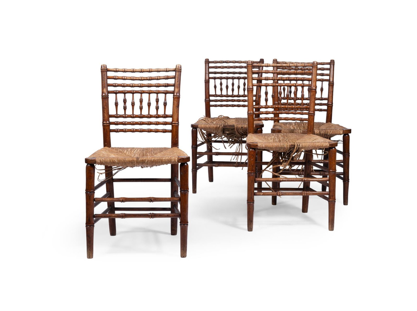 A SET OF FOUR LATE REGENCY ASH SIMULATED BAMBOO SIDE CHAIRS, EARLY 19TH CENTURY: A SET OF FOUR LATE REGENCY ASH SIMULATED BAMBOO SIDE CHAIRSEARLY 19TH CENTURYEach with a rush seat84cm high, 46cm wide, 42cm deep