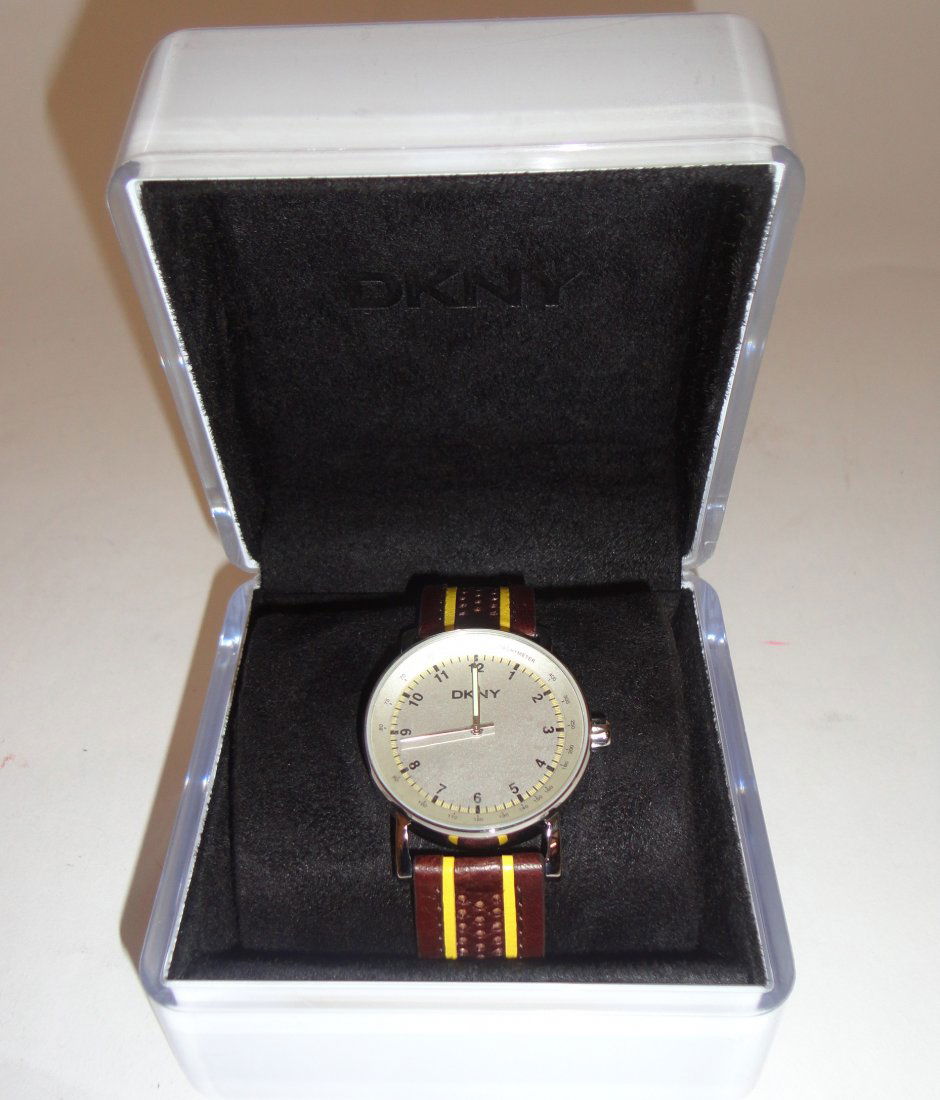 Ted Baker, a gentleman's stainless steel bracelet: Ted Baker, a gentleman's stainless steel bracelet watch, the rectangular black dial with bright green hands and sweep seconds hand, cased, boxed and with guarantee dated 2005; with a DKNY gen