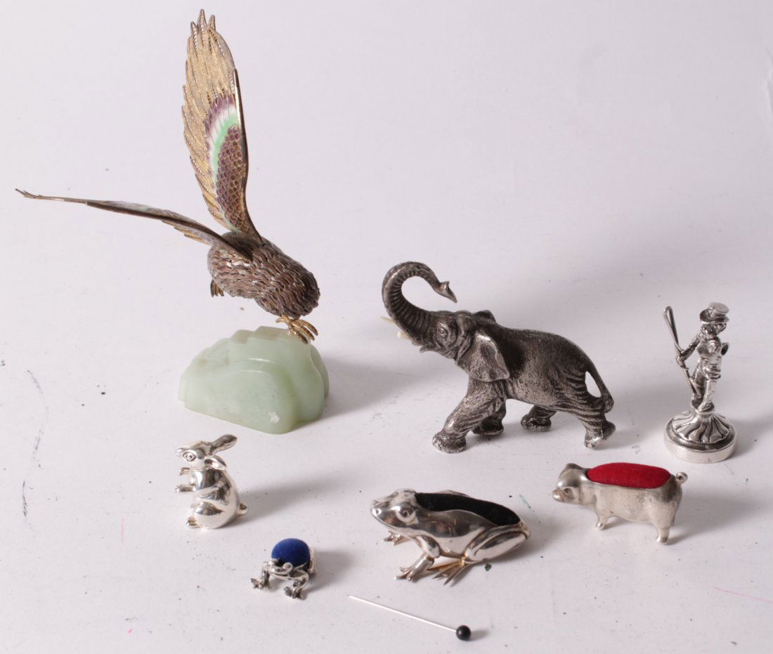 A small collection of silver coloured figures, to: A small collection of silver coloured figures, to include: a silver coloured pig pin cushion, 4cm long; a silver coloured rabbit, 2.6cm high; two silver coloured frog pin cushions, the larges