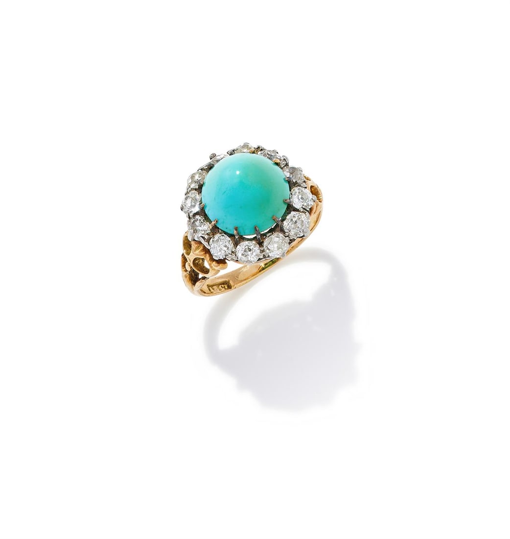 A TURQUOISE AND DIAMOND CLUSTER RING: A TURQUOISE AND DIAMOND CLUSTER RING The sugarloaf cabochon turquoise within a surround of old European cut diamonds, to an associated shank with pierced shoulders, stamped 18ct Size/dimensions: ring 