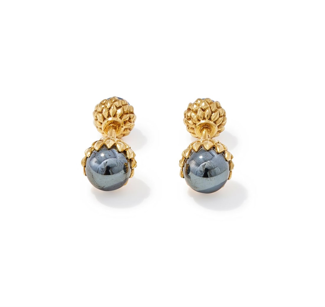 SCHLUMBERGER FOR TIFFANY & CO., A PAIR OF HEMATITE CUFFLINKS: SCHLUMBERGER FOR TIFFANY & CO., A PAIR OF HEMATITE CUFFLINKSEach acorn shaped terminal set with a hematite bead to a stylised cap, bar connectors, signed Schlumberger, Tiffany, stamped