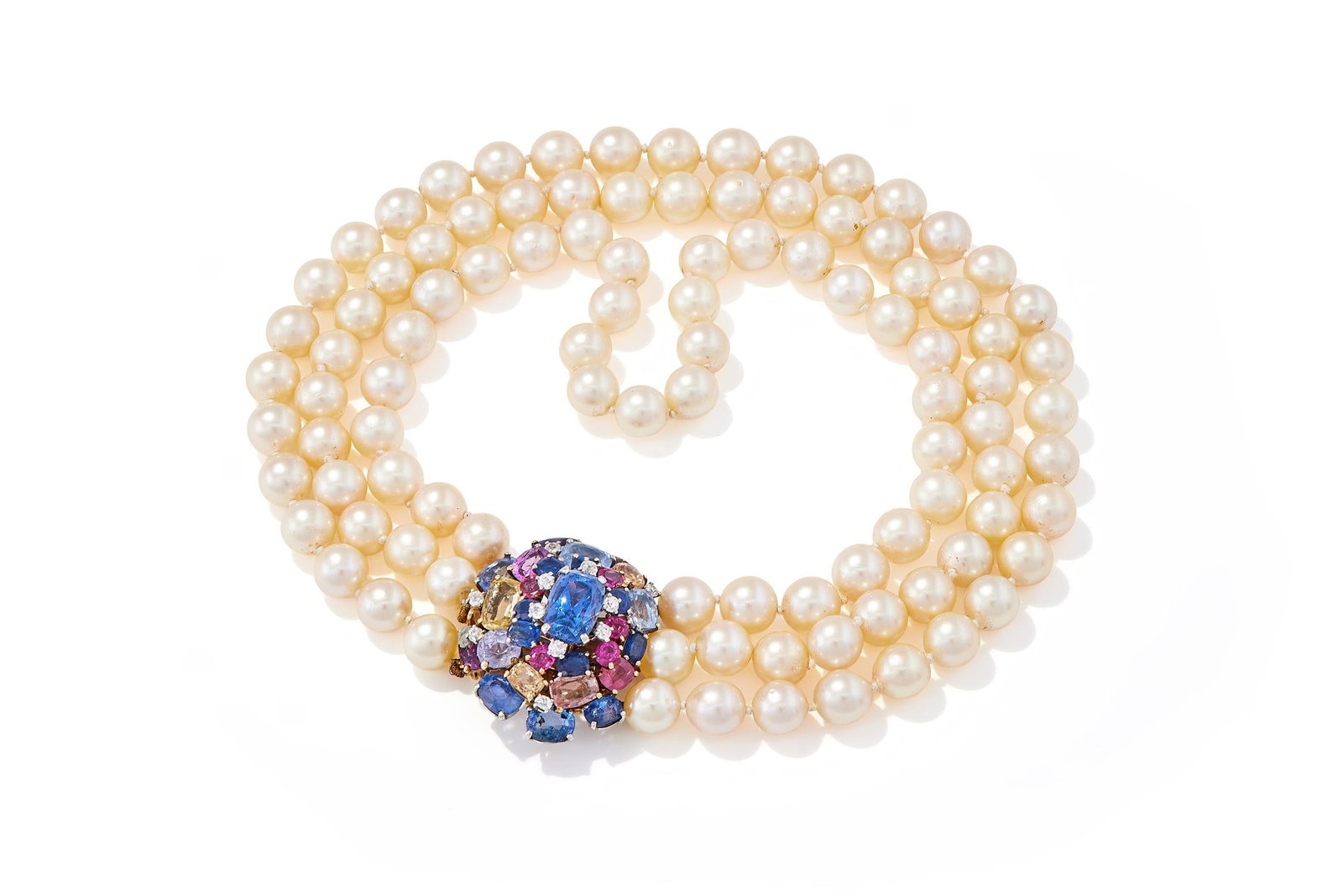 A SAPPHIRE, COLOURED SAPPHIRE, DIAMOND AND CULTURED PEARL NECKLACE: A SAPPHIRE, COLOURED SAPPHIRE, DIAMOND AND CULTURED PEARL NECKLACECIRCA 1935-40The tiered cluster clasp, set with cushion shaped sapphires, yellow, pink, purple and pinkish orange sapphires, with old 
