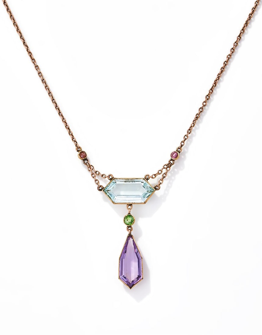 CARRINGTON & CO., AN EARLY 20TH CENTURY GEM SET PENDANT (1 of 3)
