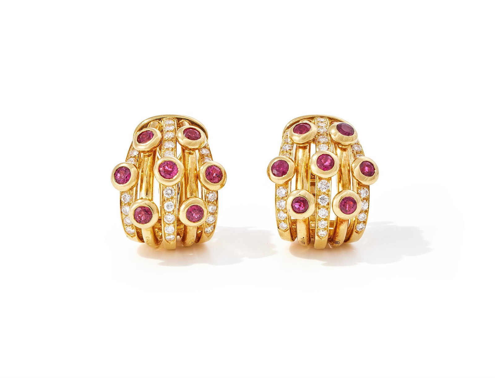 ADLER, A PAIR OF RUBY AND DIAMOND 'SERAIL' EARRINGS: ADLER, A PAIR OF RUBY AND DIAMOND 'SERAIL' EARRINGSEach designed as five alternating polished or pavé diamond set loops, collet set with circular cut rubies, signed Adler, stamped 750, Serail,