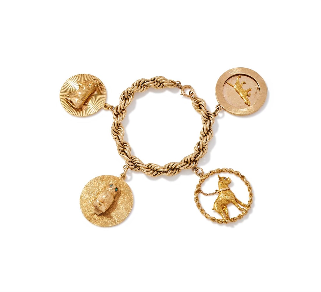 TIFFANY & CO., TWO MID 20TH CENTURY DISC CHARMS: TIFFANY & CO., TWO MID 20TH CENTURY DISC CHARMSThe first designed as a cow on a radiating disc, engraved 'To Millicent from her boys, October 3, 1960'; the second designed as an owl with turquoise