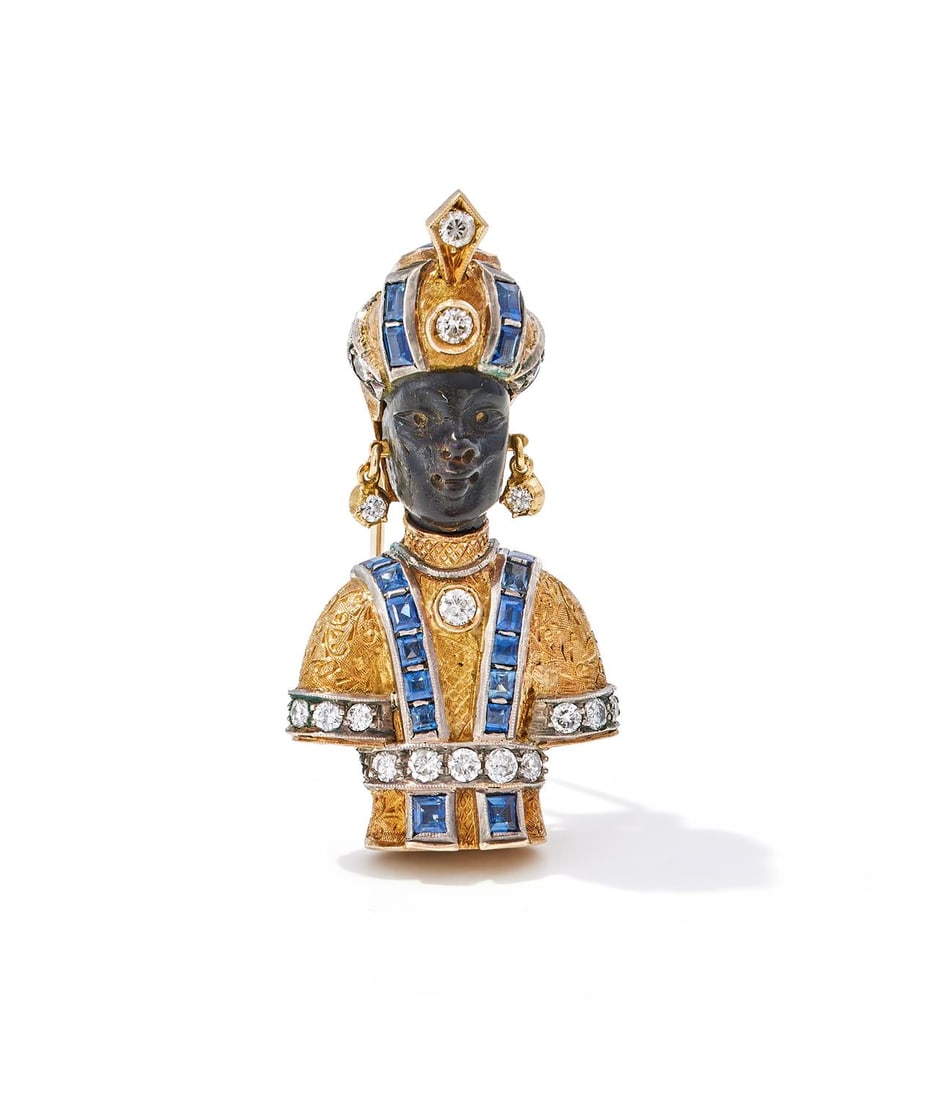 Y NARDI, A SAPPHIRE AND DIAMOND 'MORETTO' BROOCH: Y NARDI, A SAPPHIRE AND DIAMOND 'MORETTO' BROOCHThe carved tortoiseshell face, surmounted by an engraved turban, collet set with a sugarloaf cabochon sapphire and set with calibré cut sapphire an