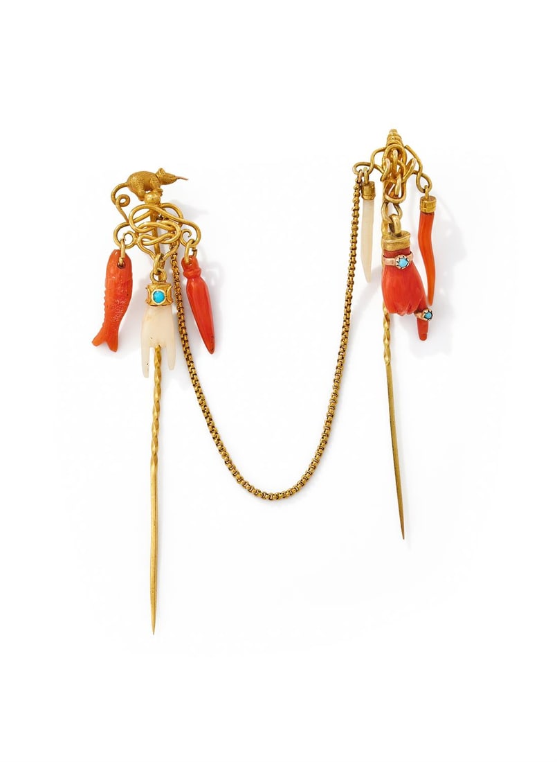 Y A 19TH CENTURY ITALIAN CORAL DOUBLE STICKPIN: Y A 19TH CENTURY ITALIAN CORAL DOUBLE STICKPIN One with a textured mouse finial above a lovers knot, suspending traditional Italian red and white coral charms comprising the Cornicello, Mano Cornuta