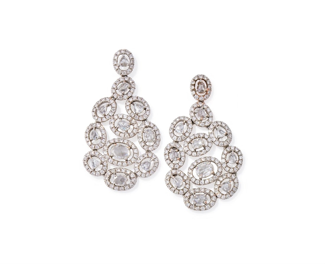 A PAIR OF DIAMOND PENDENT EARRINGS: A PAIR OF DIAMOND PENDENT EARRINGSEach composed of rose and brilliant cut diamond cluster panels, mounted in 14 carat gold, UK hallmark Size/dimensions: 3.5cm long Gross weight: 8.9 grams